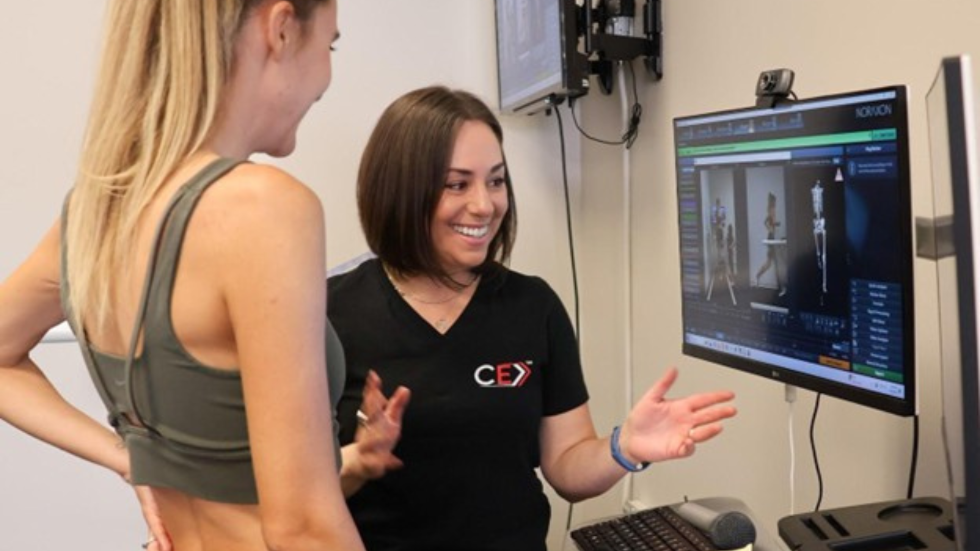 Competetive Edge Promo Clinician and athlete review motion capture data on a Noraxon computer screen during a movement assessment.